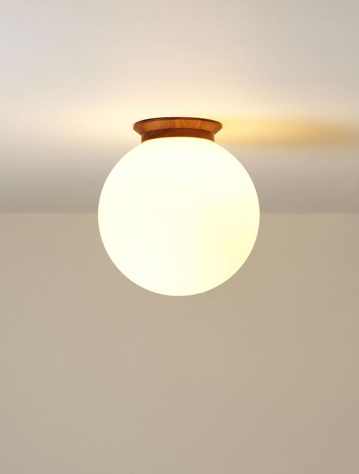 a ceiling light that is on in a room with white walls and flooring,