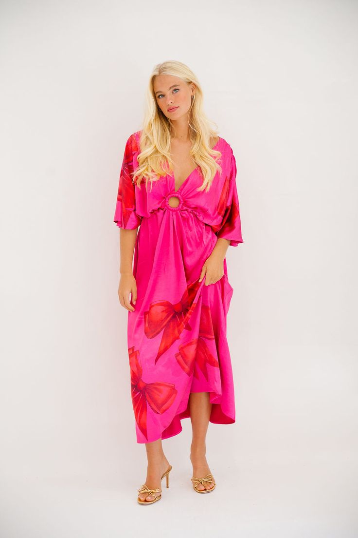 Be the queen of style with our Wrap Queen Pink Dress! Featuring playful red bows, a circle cutout design, and a deep v-neck, this short-sleeved maxi dress is perfect for any occasion. Its loose fitting silhouette adds comfort and flair to your wardrobe. Stand out in this quirky and fun number! All orders are currently shipping within 14 business days. To receive item quicker, expedited shipping is available at checkout. **All Christmas orders must be placed with expedited shipping to guarantee d Wardrobe Stand, Rancher Hat, Short Sleeve Maxi Dresses, Cutout Design, Sequin Tank, Pink Sequin, A Circle, Red Bow, Maxi Dress With Sleeves