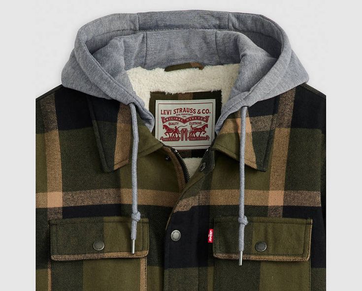 Embrace rustic charm and cozy warmth with our cotton plaid shirt jacket, featuring a full interior sherpa lining and an attached jersey hood. Crafted from soft cotton plaid fabric, this jacket effortlessly combines style and comfort for a versatile addition to your wardrobe. Soft cotton plaid fabric offers a classic and stylish look with a touch of rustic charm. Full interior sherpa lining provides exceptional warmth and comfort, making it perfect for chilly days. Attached jersey hood adds a casual and laid-back vibe to the jacket's design. Zip-front closure with snaps allows for easy on-and-off and adds a timeless aesthetic. Versatile piece that can be dressed up or down, suitable for various occasions from outdoor adventures to casual outings. Winter Flannel Shacket For Outdoors, Winter Outdoor Flannel Shacket, Winter Cotton Shacket With Fleece Lining, Plaid Cotton Hooded Jacket For Fall, Casual Fleece-lined Shacket For Cold Weather, Casual Shacket With Fleece Lining For Cold Weather, Plaid Hooded Flannel Outerwear, Plaid Cotton Outerwear With Fleece Lining, Casual Plaid Outerwear With Fleece Lining