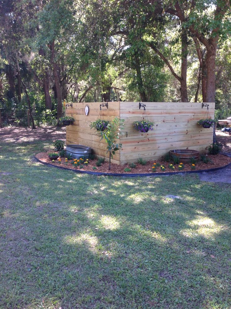 a wooden bench sitting in the middle of a lush green park