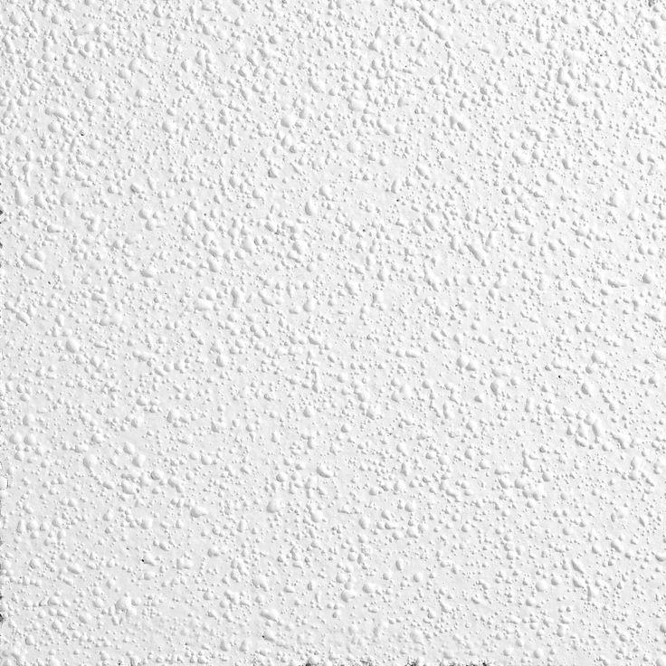 a white wall that has some black and white paint on it