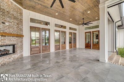 a large open floor plan with french doors and brick fireplace in the center is shown