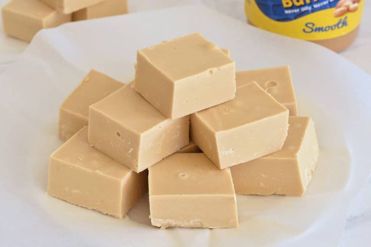 a pile of peanut butter fudges sitting on top of a white plate