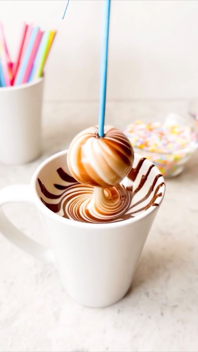 a cup filled with hot chocolate sitting on top of a table