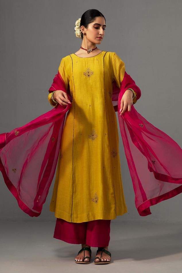 Yellow kurta with floral hand embroidery and contrast piping detailing. Paired with pant and dupatta.
Components: 3
Pattern: Embroidered
Type Of Work: Floral
Neckline: Round
Sleeve Type: Three quarter
Fabric: Kurta and Pant: Chanderi, Dupatta: Silk Organza
Color: Yellow
Other Details: 
Contrast hand embroidery
Attached lining
Length : 44 inches
Weight : 1 kg
Occasion: Wedding - Aza Fashions Yellow Kurti, Yellow Kurta, Chanderi Dupatta, A Line Kurta, Kurta With Pants, Contrast Piping, Silk Organza, Kurta Set, Set For Women