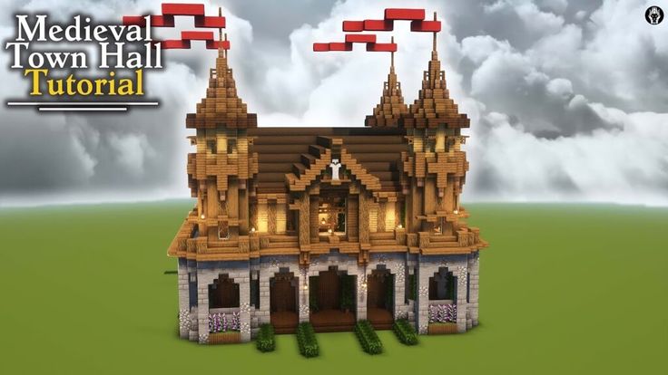 the medieval town hall is made out of legos and has red flags flying from it