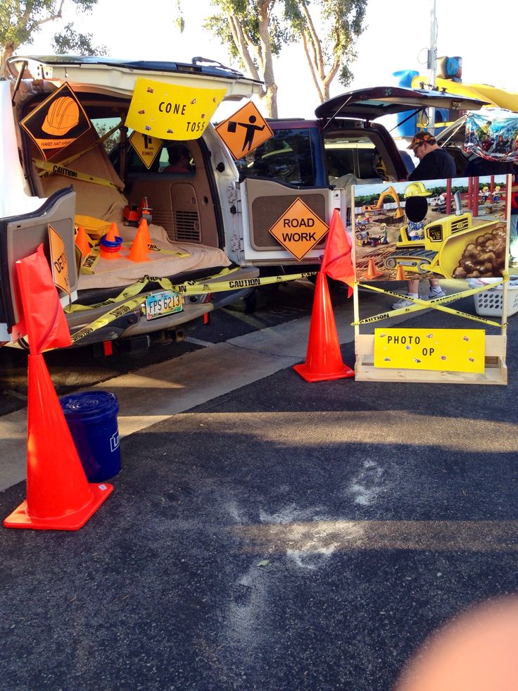 the back end of a van is blocked off by orange traffic cones and caution signs