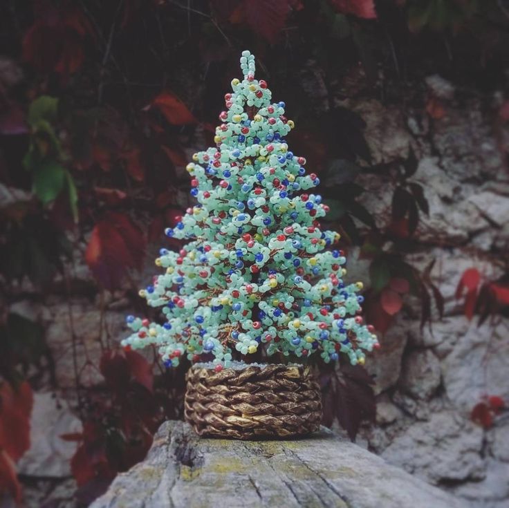 a small christmas tree sitting on top of a rock