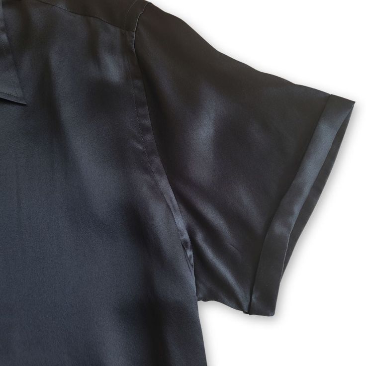 Upgrade your wardrobe with our men's black short sleeve silk shirt, crafted from luxurious 100% Mulberry Silk. The shirt features sleek black buttons with gold trim, adding a touch of sophistication to its timeless design. Available in slim fit, modern fit, and relaxed fit, this shirt offers a perfect balance of style and comfort. The smooth, lightweight silk fabric is ideal for staying cool and stylish during warmer months. Experience the elegance and comfort that our silk shirts provide. With Luxury Collared Tops For Evening, Luxury Short Sleeve Shirt For Summer, Black Silk Business Top, Black Silk Top For Business, Classic Silk Top For Night Out, Fitted Short Sleeve Black Shirt With Buttons, Classic Spread Collar Shirt For Evening, Semi-formal Solid Color Short Sleeve Tops, Luxury Short Sleeve Blouse For Summer