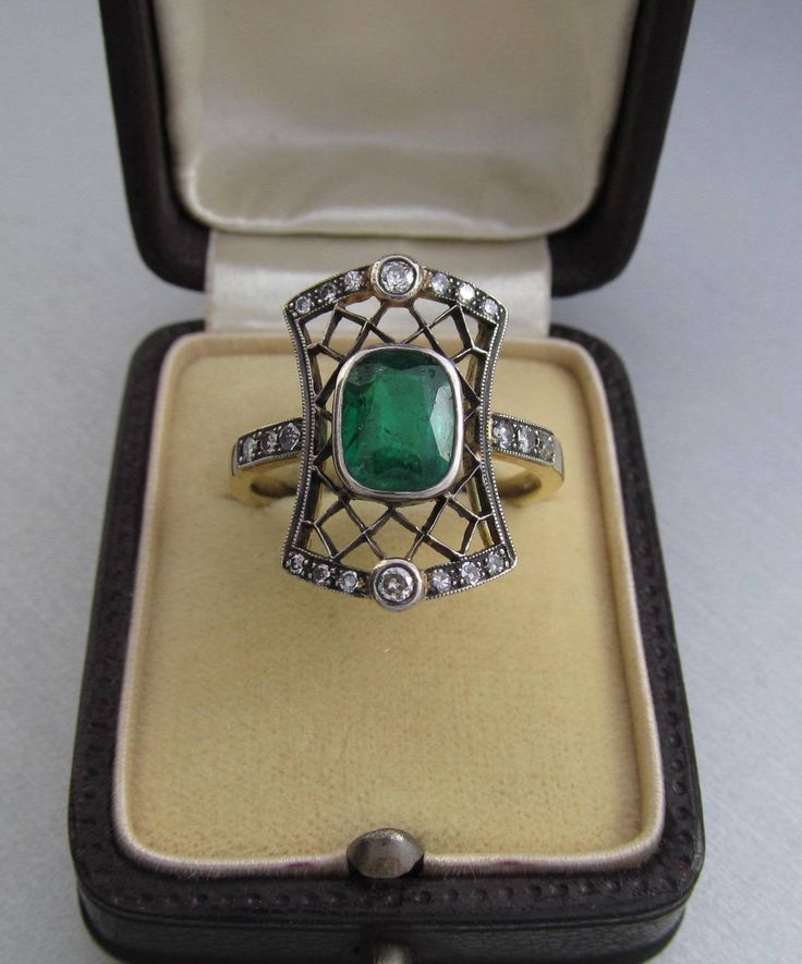 Art Deco emerald ring with diamonds, made of 14K gold and silver. With a Hungarian 14K hallmark that was used after 2016. The top part is made of silver. The head part of the ring is 0.796 inches (20 mm) long. Gemstone: one piece of emerald, 1.54 carat, its size is: 0.24 inches * 0.31 inches (6.1 mm * 7.8 mm) The emerald has inclusions which unfortunately affects the surface of the stone as well. I tried to make photos of that. Additional gemstone details: 20 single cut diamonds Carat weight: 0. Elegant 14k Stamped Emerald Ring, Gold Rings With Single Cut Diamonds And Emerald, Vintage Emerald Diamond Ring With Hallmark, Art Deco Emerald Ring With Rose Cut Diamonds, Art Deco Green Emerald Ring With Rose Cut Diamonds, Luxury Green Diamond Ring Stamped 14k, Heirloom Green Diamond Ring With Single Cut Diamonds, Antique Emerald Cut Emerald Ring, Antique Green Emerald Cut Emerald Ring