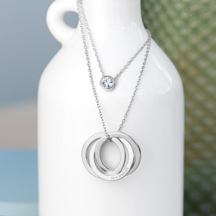 Crafted with precision and passion, our stylish Personalised Russian Ring Layered Necklace necklace is a symbol of unity and everlasting bonds, making it the perfect Valentine’s, birthday or Anniversary gift for her. It’s a timeless and elegant piece of jewellery that captures the essence of enduring love and the innate connection you both share. The centrepiece of this stunning necklace is a trio of intertwined rings, each representing a different aspect of your unique connection. These rings are delicately crafted from either gold or silver, ensuring both durability and a luxurious shine that will gracefully adorn her neckline whenever she wears it. On top of this beautiful accessory off, on a separate section of chain, a stunning crystal glistens away, adding an extra layer (quite liter Si Clarity Modern Jewelry For Anniversary, Silver Promise Jewelry With Birthstone, Silver Birthstone Jewelry For Promise, Timeless Silver Jewelry For Promise, Modern Wedding Jewelry With Birthstone, White Gold Birthstone Jewelry For Promise, White Gold Promise Jewelry With Birthstone, Modern Jewelry Gift With Vs Clarity, Modern Jewelry Gifts With Vs Clarity