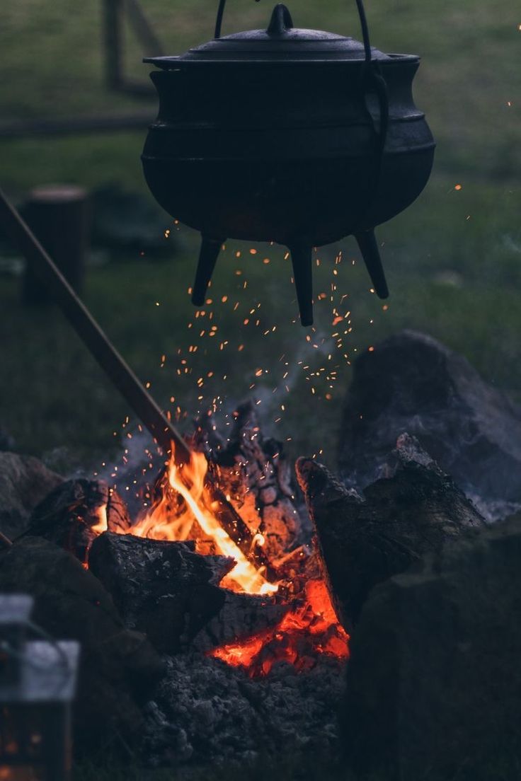 a pot is cooking over an open fire