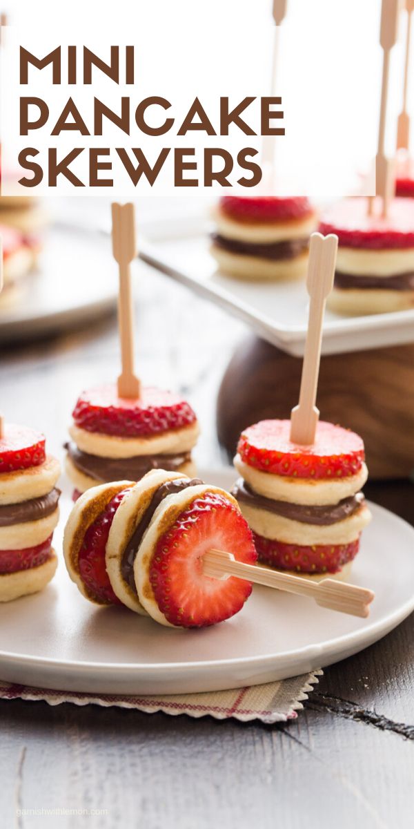 mini pancake skewers on a plate with strawberries and strawberrys in them