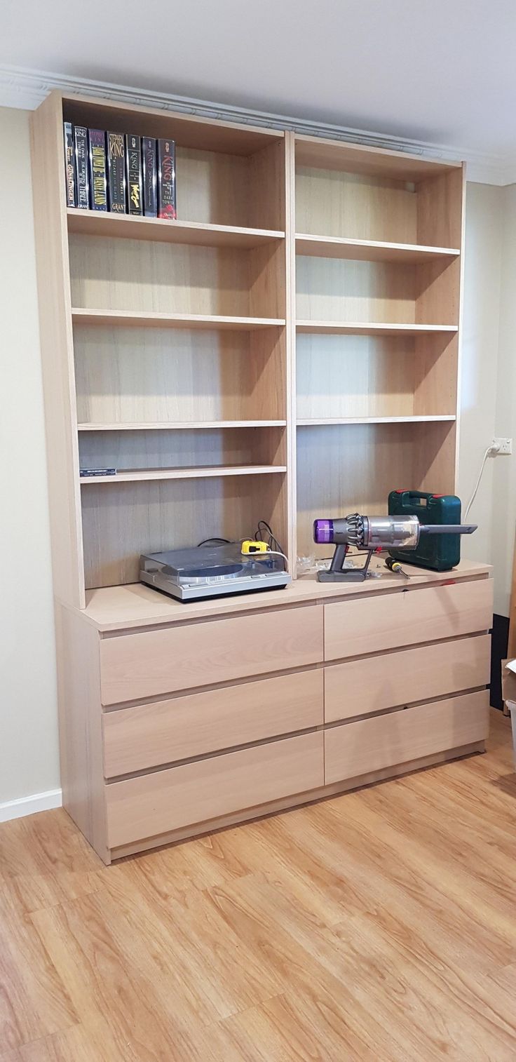 an empty room with bookshelves and wooden floors