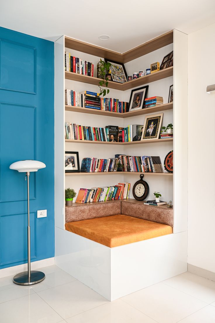 a room with bookshelves and shelves filled with various types of books on them