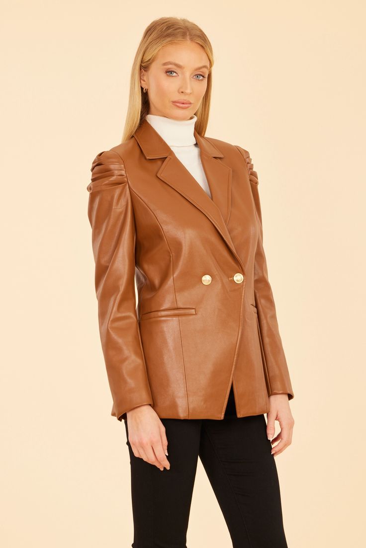 Combine edgy and elegant with our Faux Leather Ruched Shoulder Blazer. This statement piece is made of faux leather and features dramatic ruched shoulders and a simple double-breasted design for a classic touch. The blazer's tailored silhouette flatters any figure and is ideal for layering over your favorite autumn outfits. Available in rich Rust and classic Black. Faux leather Ruched shoulders Double-breasted Gold buttons Available in Rust and Black Dry clean Style: 75598 Final Sale Item Elegant Double-breasted Leather Jacket For Formal Occasions, Elegant Brown Leather Jacket For Fall, Chic Fitted Faux Leather Outerwear, Chic Faux Leather Jacket, Chic Solid Color Faux Leather Jacket, Elegant Fitted Brown Leather Jacket, Elegant Leather Jacket For Evening In Fall, Luxury Fall Blazer With Structured Shoulders, Formal Fitted Faux Leather Jacket