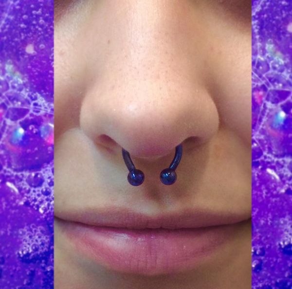 the nose is covered in purple bubbles and has two different types of piercings on it