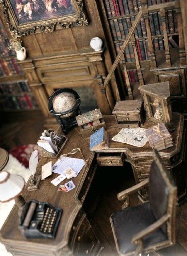 there is a desk and chair in the room with bookshelves on the wall