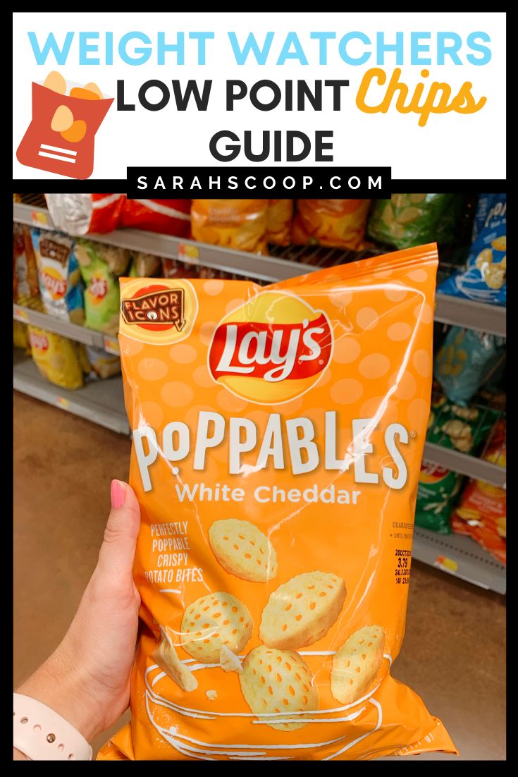 a hand holding a bag of lays poppables white cheddar chips in a store