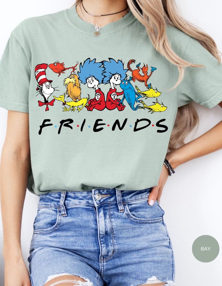 Join the whimsical world of Dr. Seuss with our Seuss Squad Friends Tee! Featuring beloved characters from the enchanting stories of Dr. Seuss, this shirt brings a splash of nostalgia and fun to your wardrobe. Made from soft, premium cotton, it offers all-day comfort and durability. Whether you're a lifelong fan or introducing these classic tales to a new generation, this tee is perfect for showing off your Seuss spirit. Ideal for casual outings, school, or cozy days at home, the Seuss Squad Friends Tee is a delightful addition to any Seuss lover's collection. Embrace the joy and magic of Dr. Seuss with this charming and colorful shirt! Relaxed Fit Graphic Tee With Character Print, Cotton Crew Neck Shirt With Character Print, Relaxed Fit Crew Neck Top With Character Print, Relaxed Fit Crew Neck Shirt With Character Print, Pop Culture Crew Neck Shirt With Character Print, Fun Character Print Shirt For Spring, Spring Crew Neck Shirt With Character Print, Cotton Shirt With Pop Culture Character Print, Green Relaxed Fit Top With Character Print