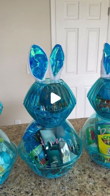 three blue glass vases with bunny ears on them