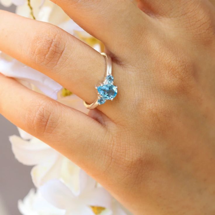 A classic cut, the pear-shaped Sienna ring with a side Swiss Blue Topaz is the ultimate ring to gift a loved one. It is a timeless piece that can always be paired with other nesting bands to elevate your look.  A ring that will never disappoint, and makes the perfect pre-engagement ring or promise ring for a friend. De Solitaire Topaz Promise Ring, Promise Solitaire Topaz Ring, Blue Topaz Solitaire Promise Ring, Pear-shaped Topaz Promise Ring, Heart Cut Blue Topaz Promise Ring, Fine Jewelry Pear-shaped Topaz Ring, Fine Jewelry Pear-shaped Birthstone Promise Ring, Heart Cut Topaz Promise Ring In Fine Jewelry Style, Fine Jewelry Blue Topaz Teardrop Rings