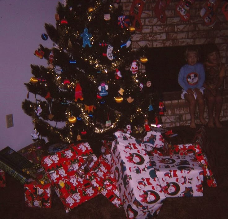 a christmas tree with presents under it