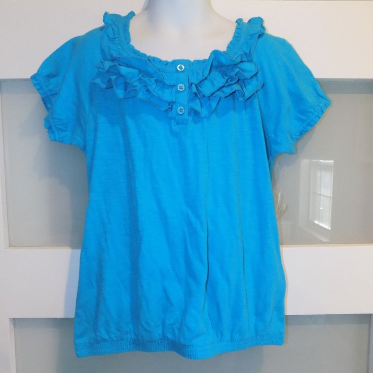 Faded Glory Solid Blue Ruffle Ss Shirt Size 7/8 (M) Girl's New Blue Cotton T-shirt With Ruffles, Blue Ruffled T-shirt For Summer, Light Blue Ruffled Short Sleeve Tops, Cute Blue Shirt For Spring, Cute Blue Short Sleeve Shirt, Cute Blue Spring Shirt, Blue Short Sleeve Shirt With Ruffles, Blue Short Sleeve Tops With Ruffles, Blue Ruffled Short Sleeve Tops