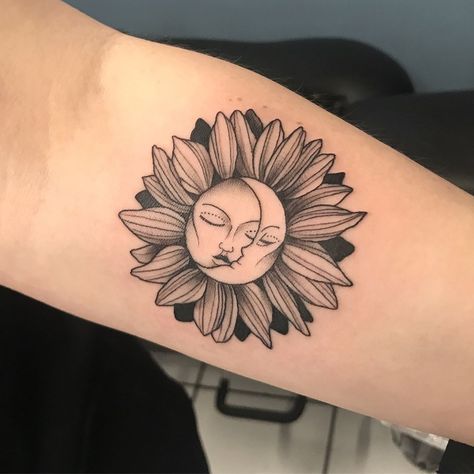 a woman's arm with a sunflower tattoo on it and a sleeping face