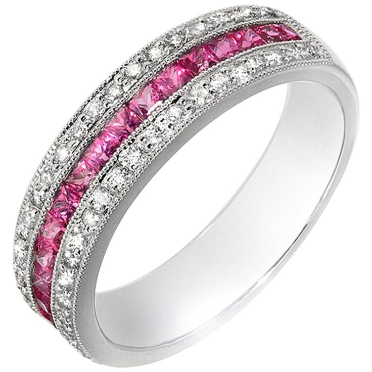 a wedding ring with pink and white stones on the inside, set in 18k white gold