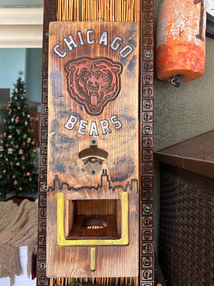 an old chicago bears bottle opener hanging from the side of a building next to a christmas tree