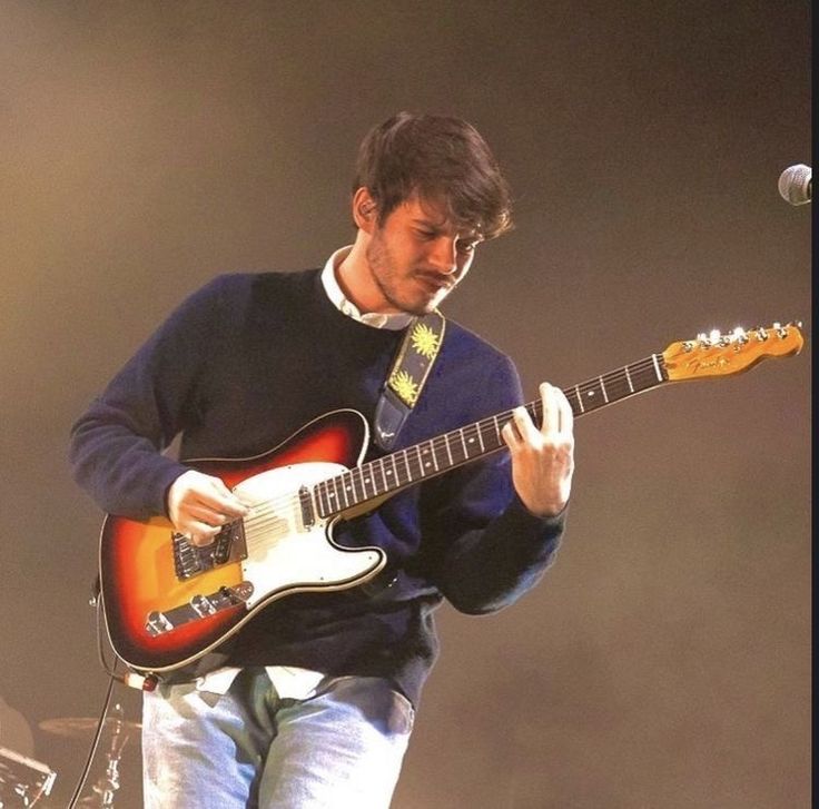 a man playing an electric guitar on stage