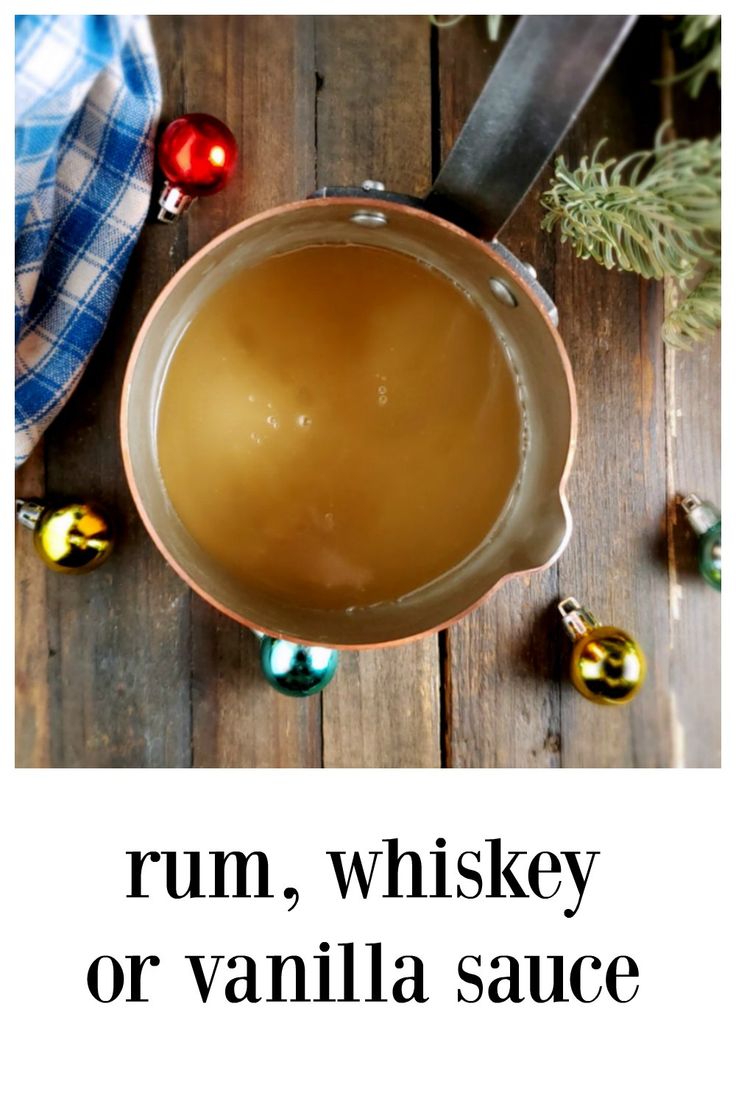 rum, whiskey or vanilla sauce on a wooden table with christmas ornaments and baubles