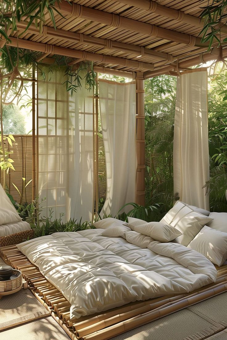 a bamboo bed with white pillows and blankets on it in a room filled with plants