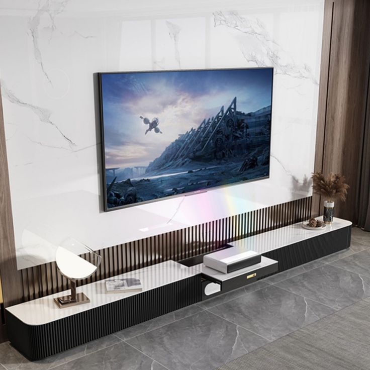 there is a television on the wall in this living room with marble floors and walls