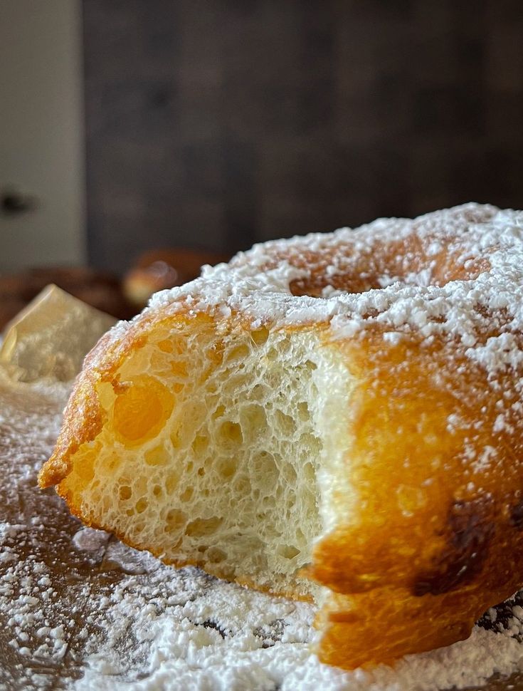 powdered sugar covered donut sitting on top of a table