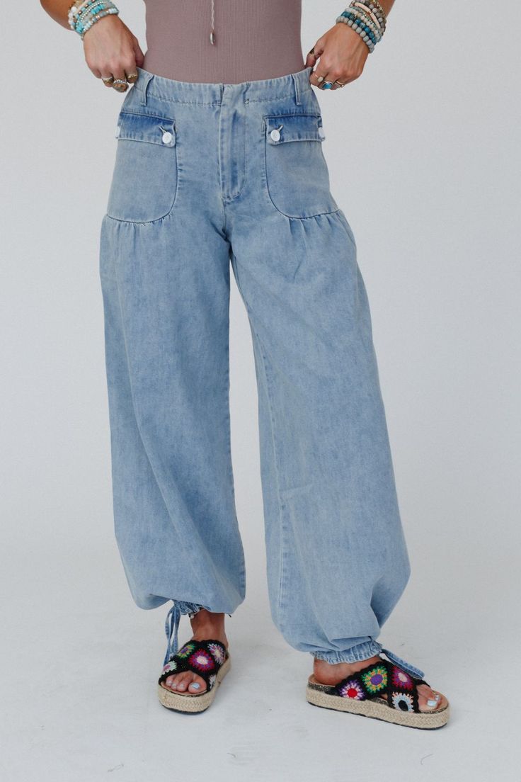 So cozy and cool, you're never going to want to take the First Things First Wide Leg Jeans off -Elevate your boho wardrobe with these these stylish and chic statement pants! Comfortable washed denim fabric Relaxed and loose wide leg silhouette Flattering mid-rise waistline with a classic button-zipper front closure and back elastic waistband So cute front patch pockets with button flaps, belt loops, and pleated details Unique drawstring ankle closures (can be worn as wide legs or jogger style!) Pre-washed Recycled Denim Blue Bottoms, Stonewashed Relaxed Fit Jeans For Spring, Casual High Rise Pre-washed Bottoms, Light Wash Relaxed Fit Bottoms In Recycled Denim, Light Wash Relaxed Fit Recycled Denim Bottoms, Relaxed Fit Light Wash Recycled Denim Bottoms, Dark Wash Stonewashed Bottoms For Spring, Hippie Straight Leg Spring Bottoms, Hippie Style Straight Leg Spring Bottoms