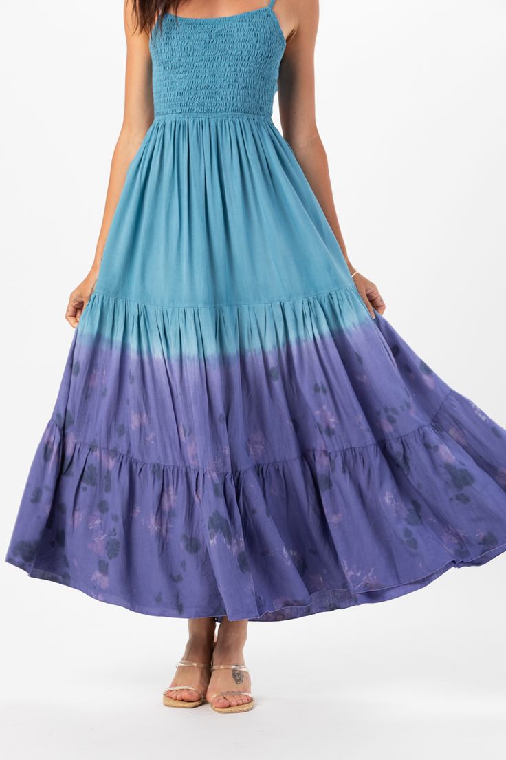 With its floor-grazing length, the Avisa Maxi Dress exudes bohemian elegance, making it perfect for everything from beach weddings to summer soirées. Whether you're dancing under the stars or strolling along the shore, this dress is sure to make you feel like a goddess. Details: 100% Rayon Hand Wash in Cold Water and Lay Flat to Dry Features: Unlined, Smocked Bodice, Self-tie spaghetti strap closure, Tassel tie detail on straps, Open back detail for an adjustable fit, Tiered Maxi Skirt. Measurem Summer Flowy Beach Cover-up Dress, Flowy Summer Dresses For Beach Wedding, Blue Floor-length Maxi Dress For Festival, Bohemian Flowy Maxi Dress, Summer Beach Sundress With Flowy Skirt, Bohemian Spring Maxi Dress For Beach Party, Flowy Bohemian Sundress For The Beach, Flowy Summer Sundress For The Beach, Summer Floor-length Dress For Beach Party