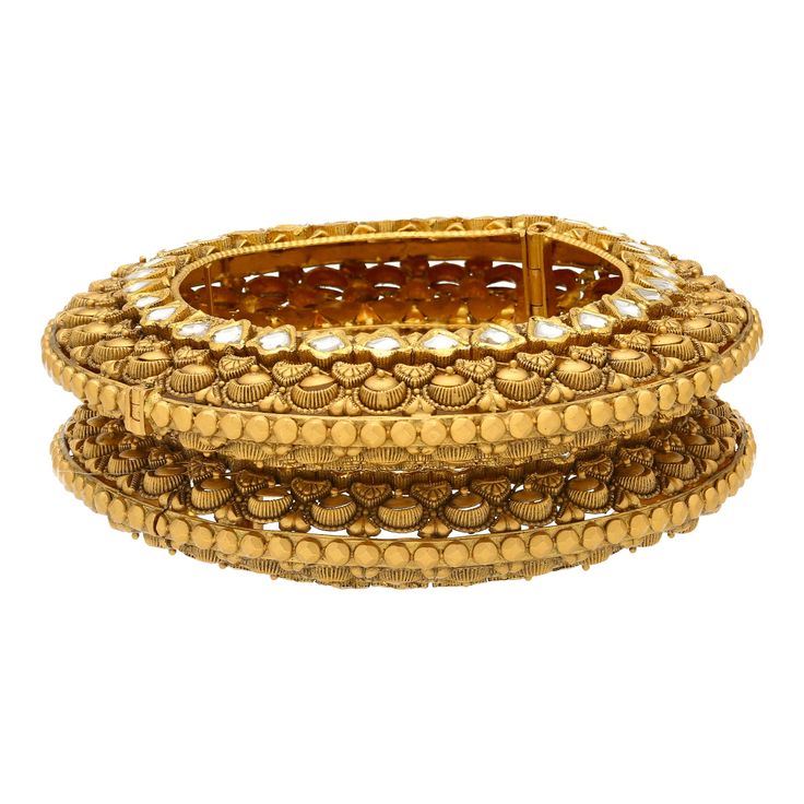 This unique pair of 22k yellow gold bangles have traditional kundan stones incorporated into the rare design. Features: • 22k yellow gold • Kundan stones • Pin screw closure. • Set of two bangles.If you're looking for quality 22k gold bangles then look no further than Virani Jewelers! Our gorgeous 22k gold bangles have one of a kind details and stunning accents that you'll have to see to believe. Whether you're shopping for gold jewelry to add to your everyday looks or a dazzling addition for an 22k Gold Bangles, Yellow Gold Bangle, Gold Bead Necklace, Bangle Set, 22k Gold, Gold Bangles, Gold Beads, Everyday Look, Design Features