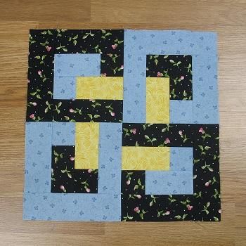 the block is made up of black and yellow squares with blue trims on them