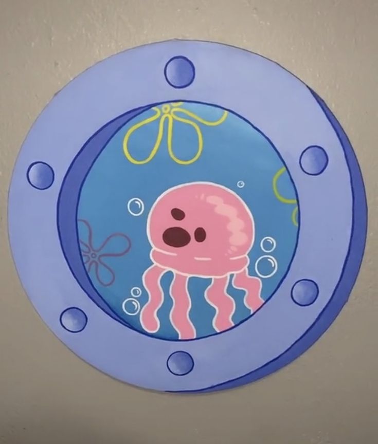 a blue plate with an octopus and jellyfish on it's side, in the shape of a circle