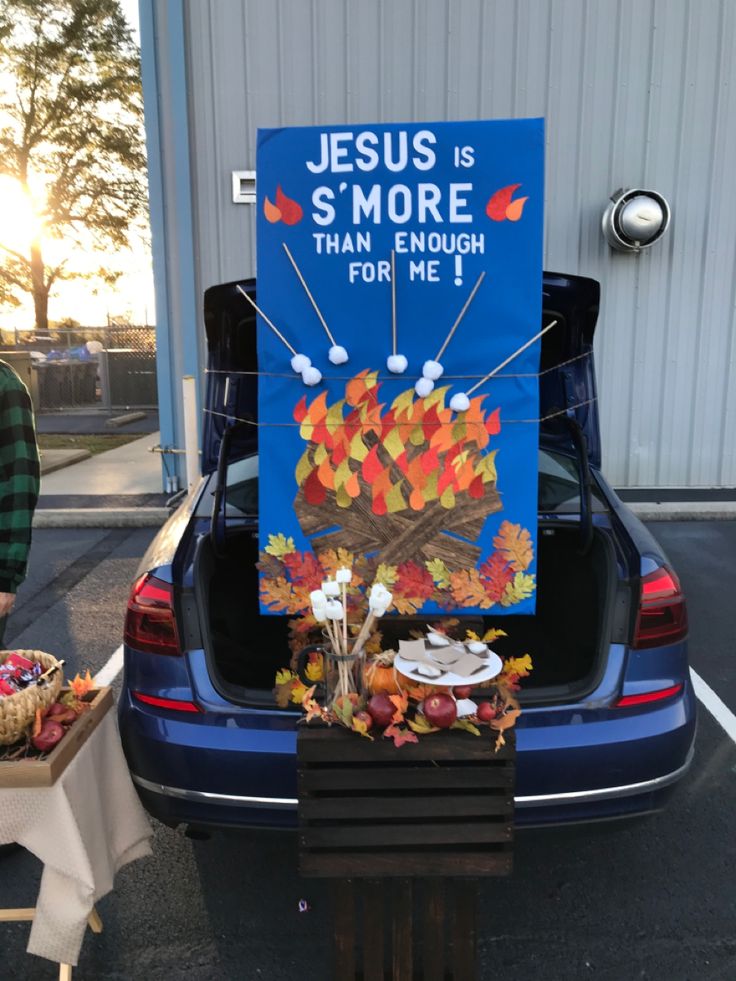 a blue car with a sign that says jesus is smore than enough for me