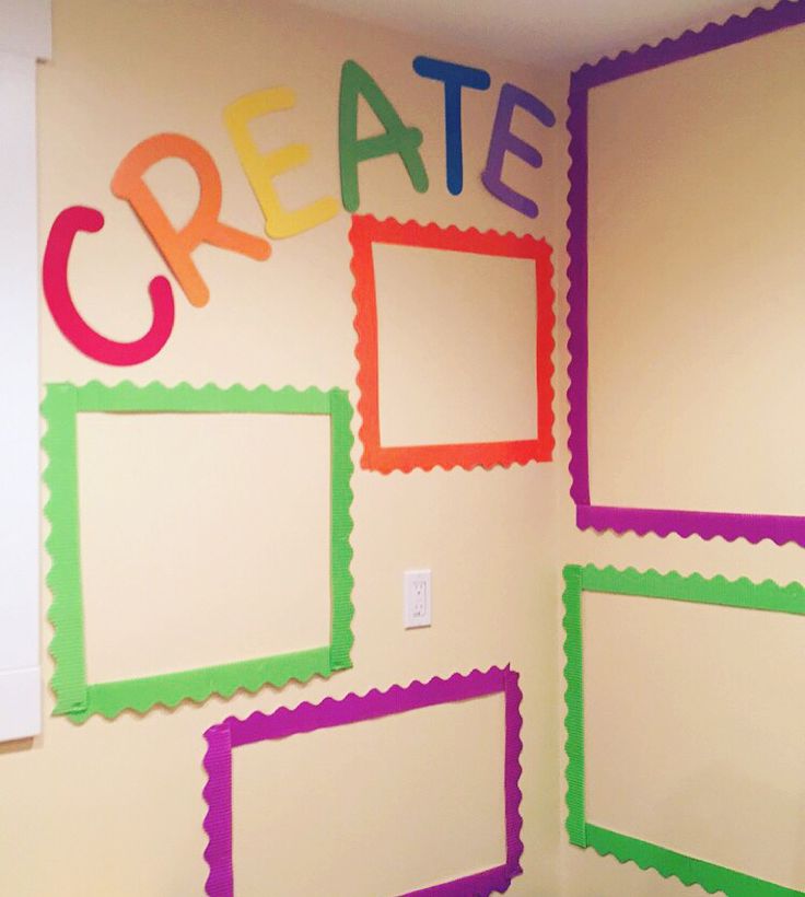 there is a wall decorated with frames and the word create on it's side