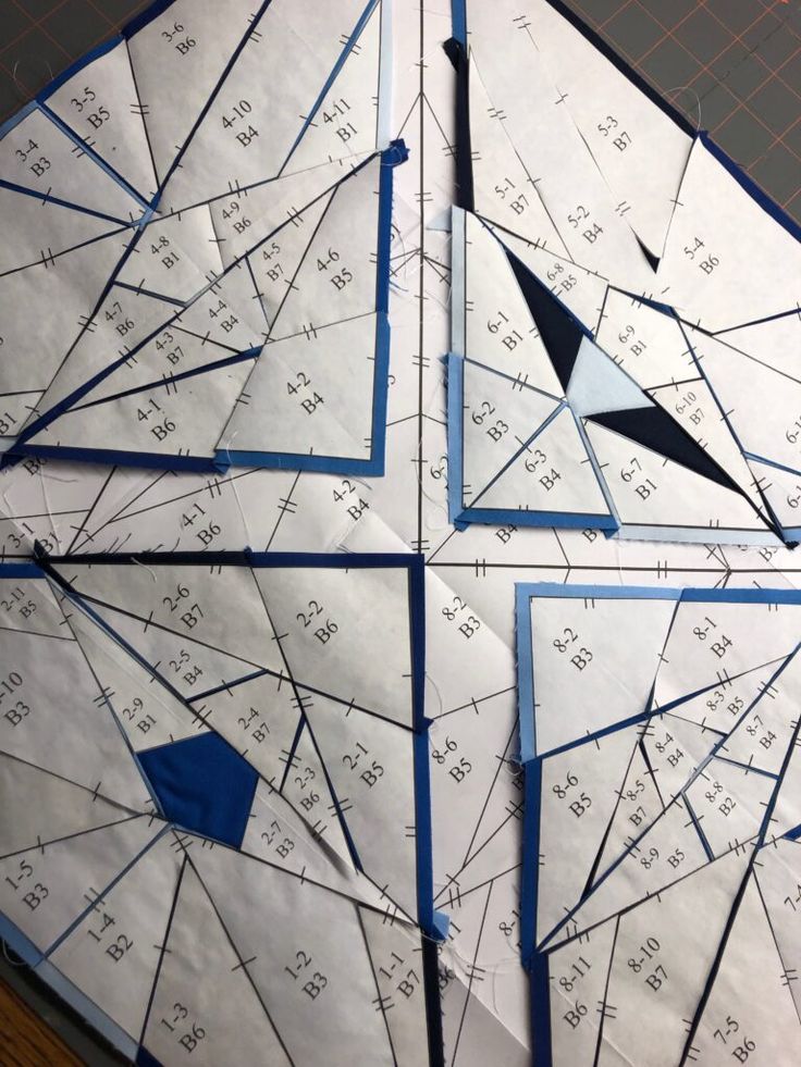 four pieces of paper with blue and white triangles on them