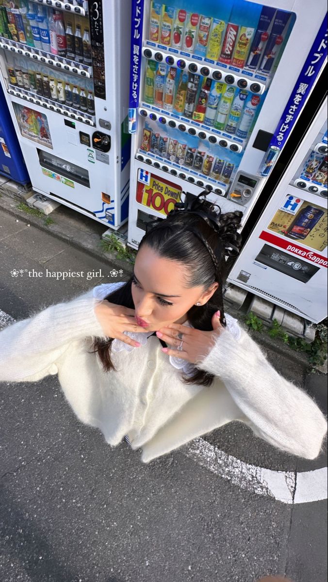 a woman standing in front of a vending machine