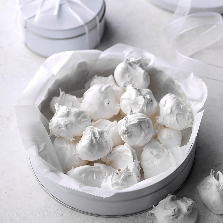 a white bowl filled with marshmallows on top of a table