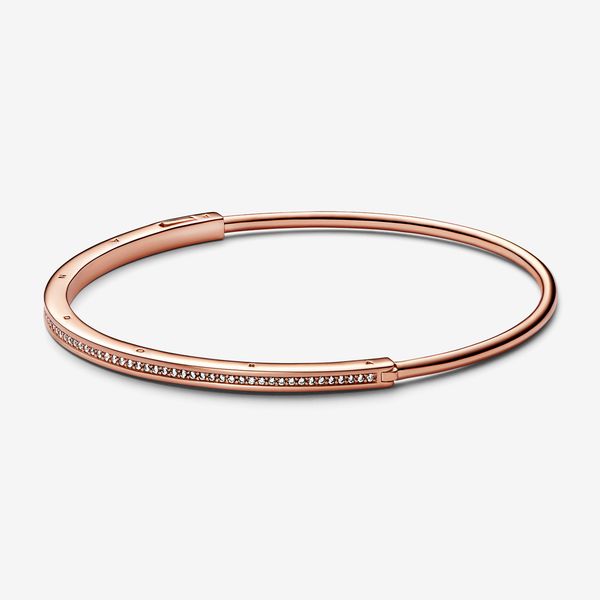 Elevate your outfit with the Pandora Signature I-D Pavé Bangle. Finished in 14k rose gold plating, this much-loved design features an architectural square-and-round profile with a channel of pavé for subtle sparkle. Stack with other Pandora Signature I-D bangles to create your own iconic look. - Pandora Signature I-D Pavé Bangle - 14k Rose gold-plated unique metal blend / Cubic Zirconia / Clear - Sz. 7.5 in Dream Proposal, Pandora Rose Gold, Pave Bangle, Classic Bangles, Bracelet Pandora, Bracelet Diamond, The Bangles, Silver Bracelets For Women, Jewellery Brand