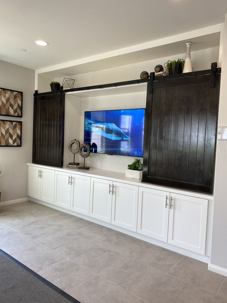 a large flat screen tv mounted to the side of a wall in a living room