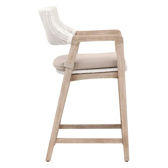 an upholstered bar stool with white wicker and beige cushion