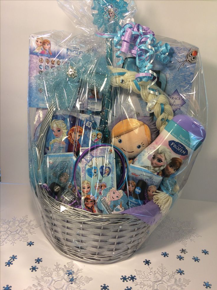 a basket filled with toys on top of a white table covered in snowflakes